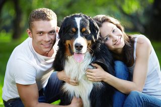 A man and women with a dog.