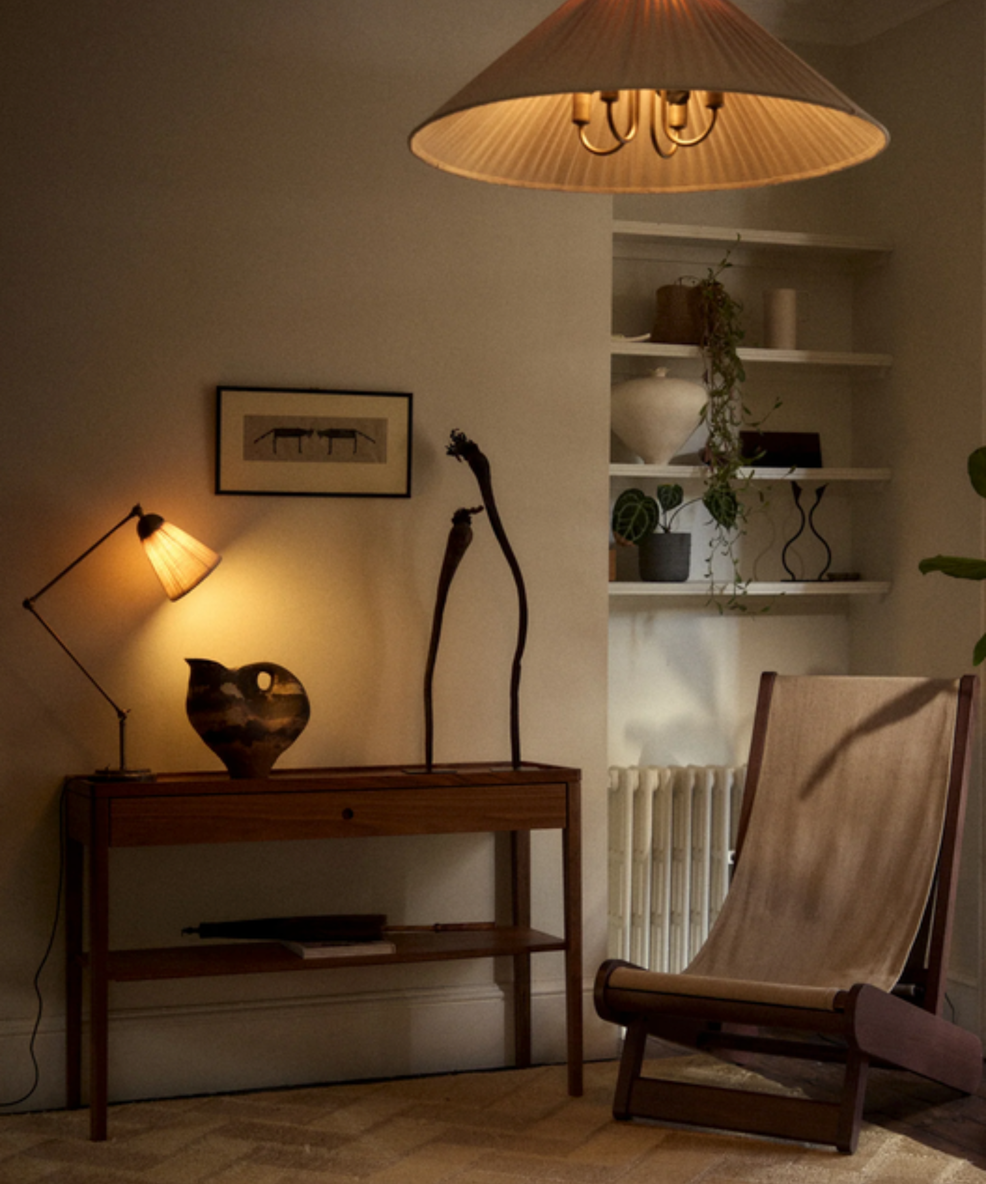 Living room scene with illuminated pendant light and table lamp