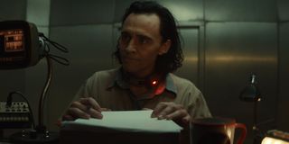 Tom Hiddleston signing papers in Loki
