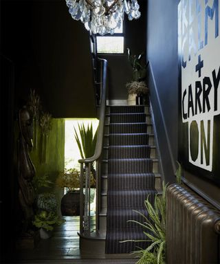 Hallway with black decor and black runner by Roger Oates