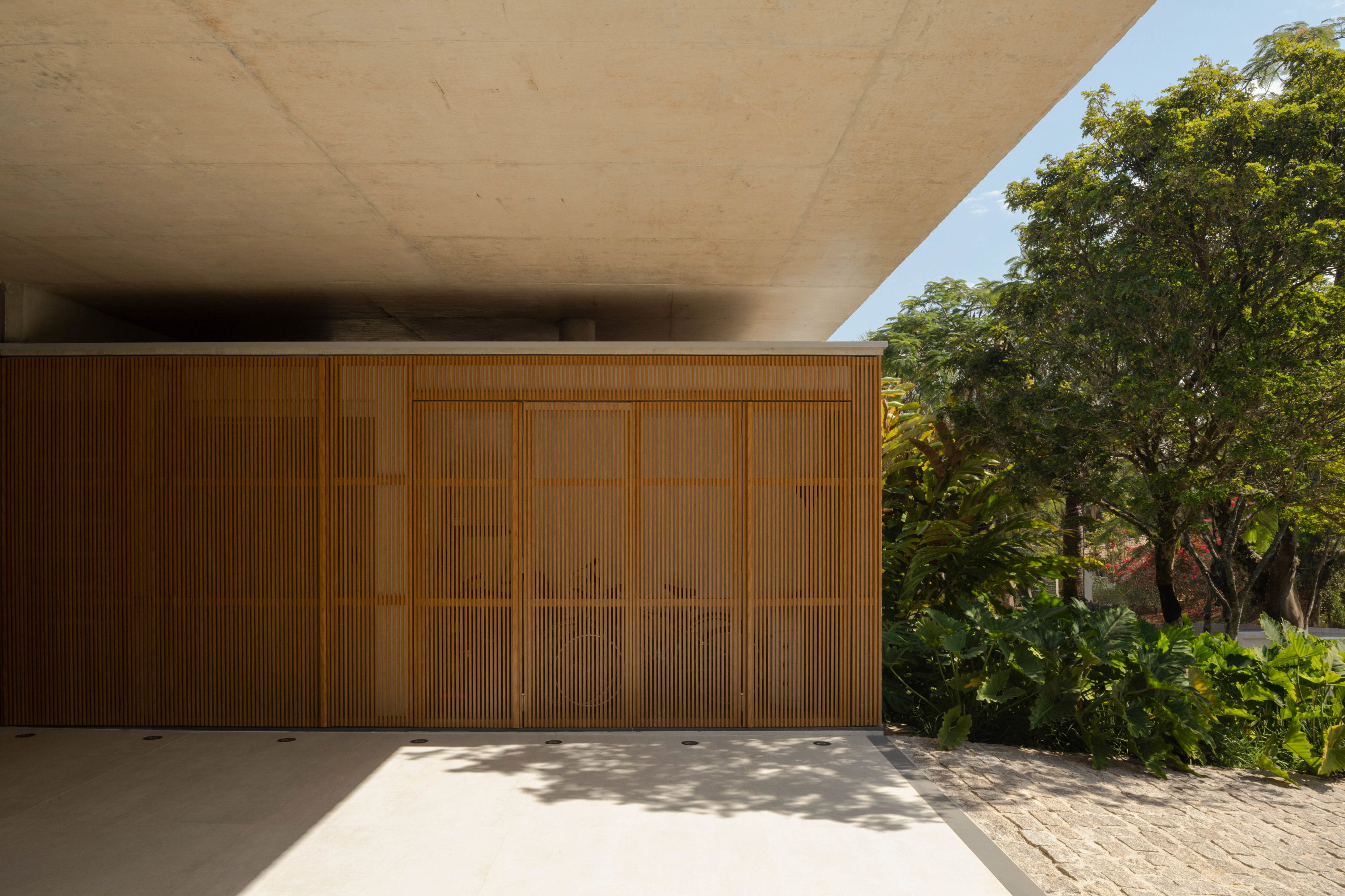 The house combines concrete structure with timber detailing