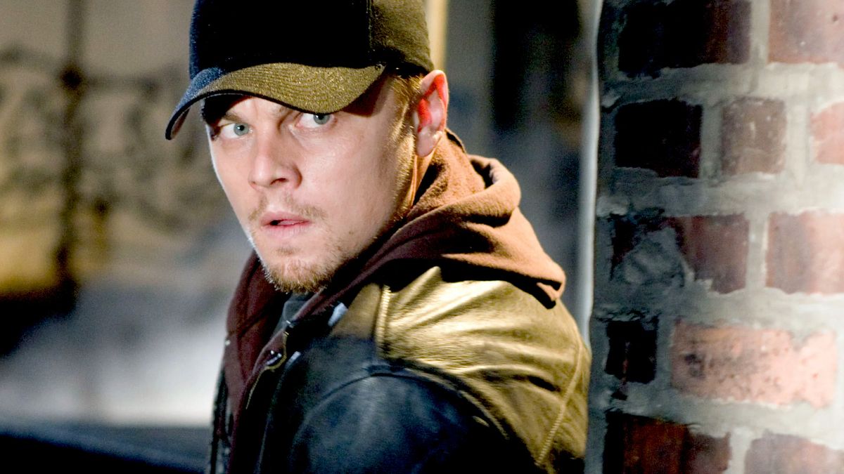 Leonardo DiCaprio as Trooper William &quot;Billy&quot; Costigan Jr. undercover and sneaking next to a wall during a scene in The Departed. 