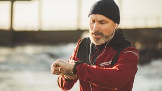 Is running bad for your knees? Image shows man reading smart watch