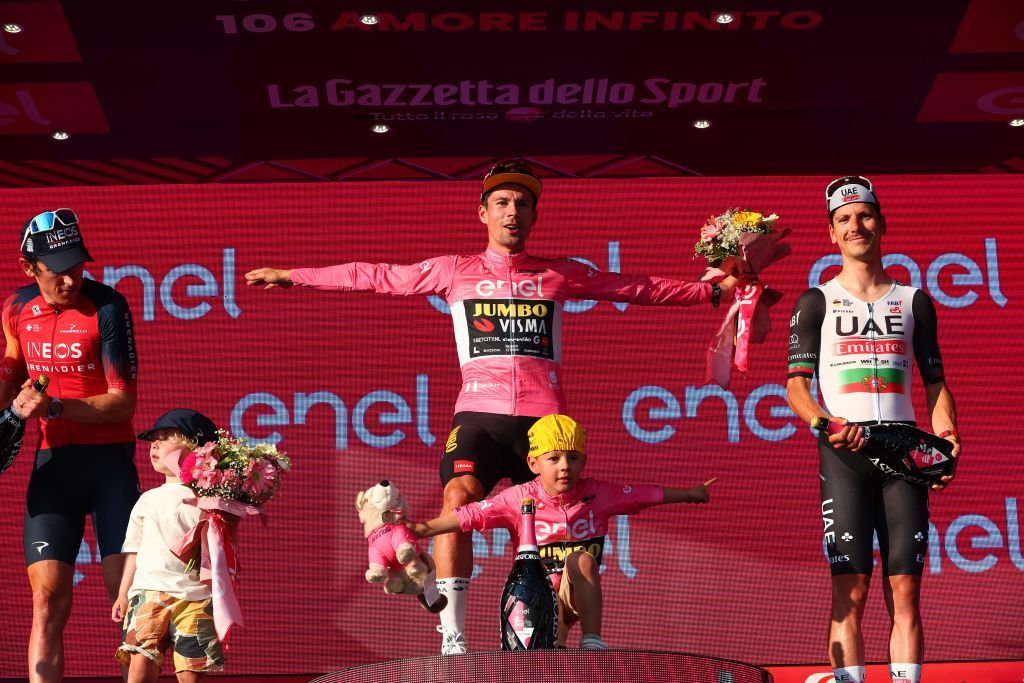 Overall winner JumboVismas Slovenian rider Primoz Roglic C celebrates on the podium after winning the Giro dItalia 2023 cycling race in Rome on May 28 2023 as secondplaced INEOS Grenadierss British rider Geraint Thomas L and thirdplaced UAE Team Emiratess Portuguese rider Joao Almeida look on Photo by Luca Bettini AFP Photo by LUCA BETTINIAFP via Getty Images