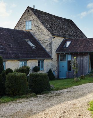 exterior of barn conversion showing tall Dutch barn