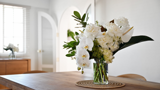 Vase with flowers on dining room table