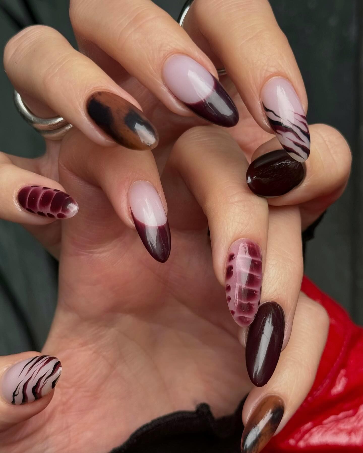 A mismatched set of nails with zebra stripes.