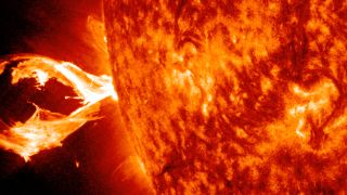 claw-shaped solar flare bursting from the sun 