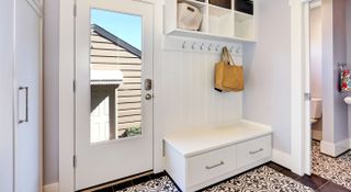 White entryway with shoe and coat storage