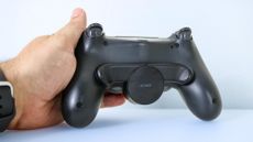 The DualShock 4 Back Button Attachment attached to a controller on a desk