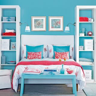 bedroom with blue wall and white shelves