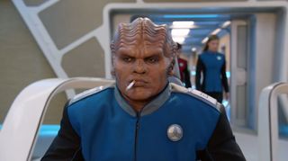 The Marlborough Moclan. Lt. Cmdr. Bortus (Peter Macon) becomes addicted to cigarettes after a time capsule is found in "Lasting Impressions."