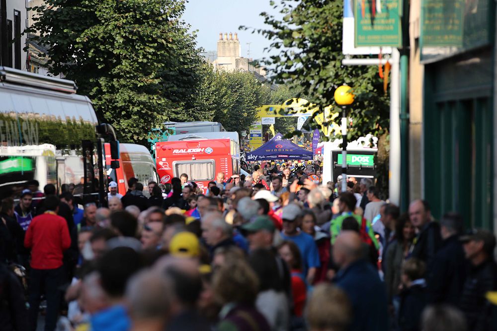 Crowds fill the streets near team parking.
