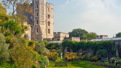 gardens at Windsor Castle with orange roses, benches and water feature