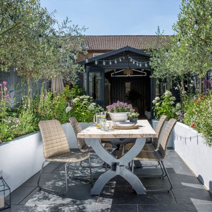 A modern garden, featuring stone walls, wild flowers and a seating area (Lizzie Orme)