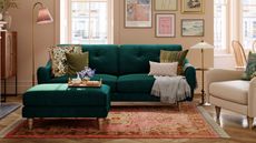 The best colors for north-facing rooms are useful to know. Here is a living room with beige walls with wall art prints on, a dark green velvet couch, a cream armchair, a gold lamp in the middle of them, and a peach rug
