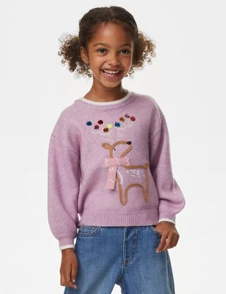 A young girl wearing Reindeer Knitted Jumper