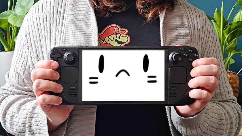 Phil Hayton holding Steam Deck OLED with mascot face on screen with thrown.