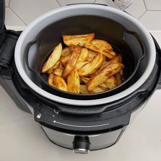 Ninja Foodi 9-in-1 Multi-Cooker with cooked potato wedges inside
