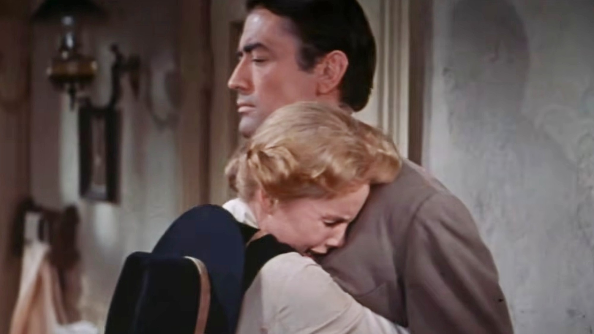 A crying Carroll Baker holding Gregory Peck tightly in The Big Country