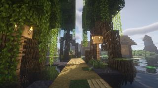 Minecraft seeds - Mangrove tree roots growing over top of a wooden path leading to a small village