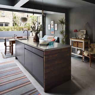 Open plan kitchen extension with island painted in black.
