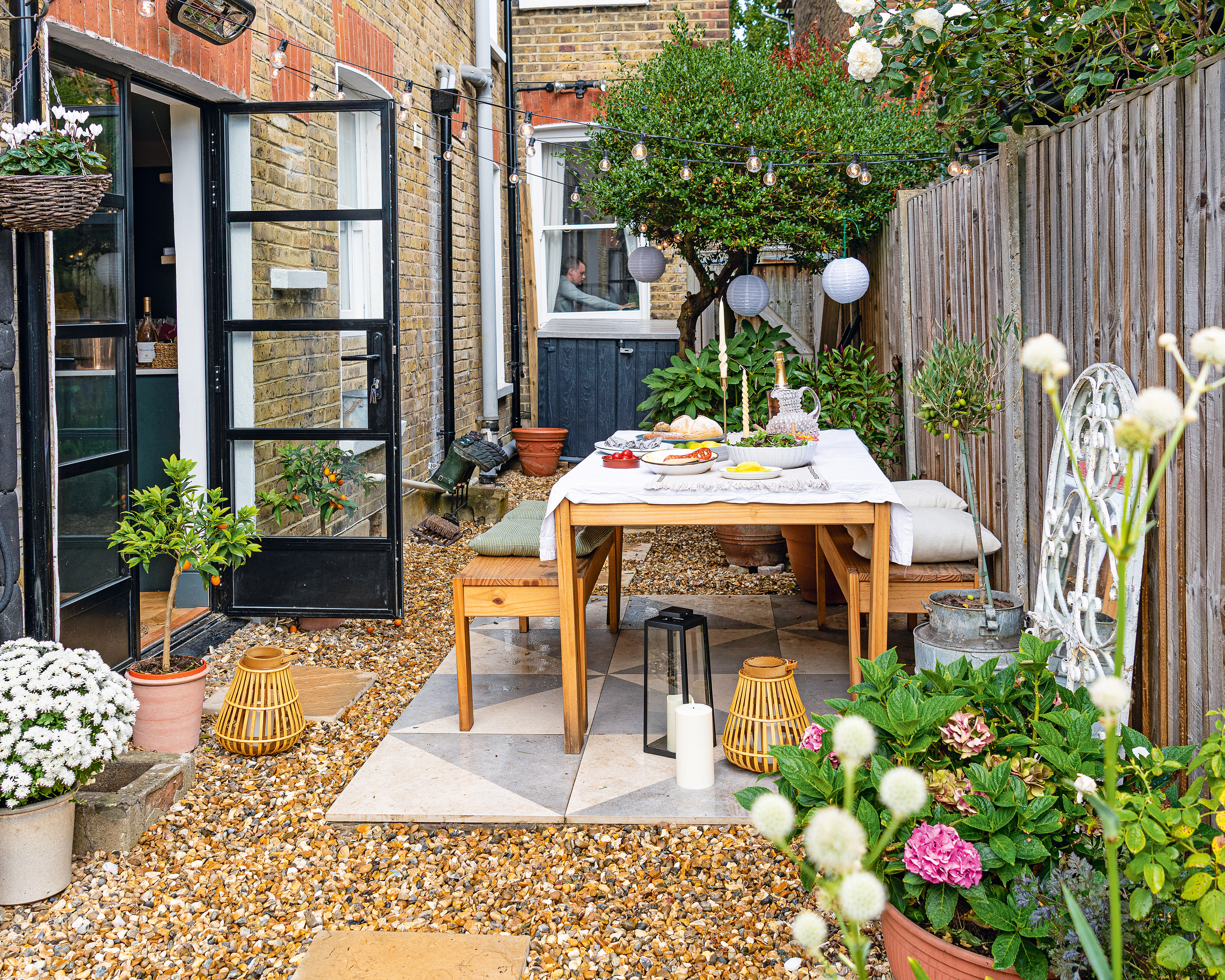 patio area with dining benches, patterned floor tiles and Crittal style doors