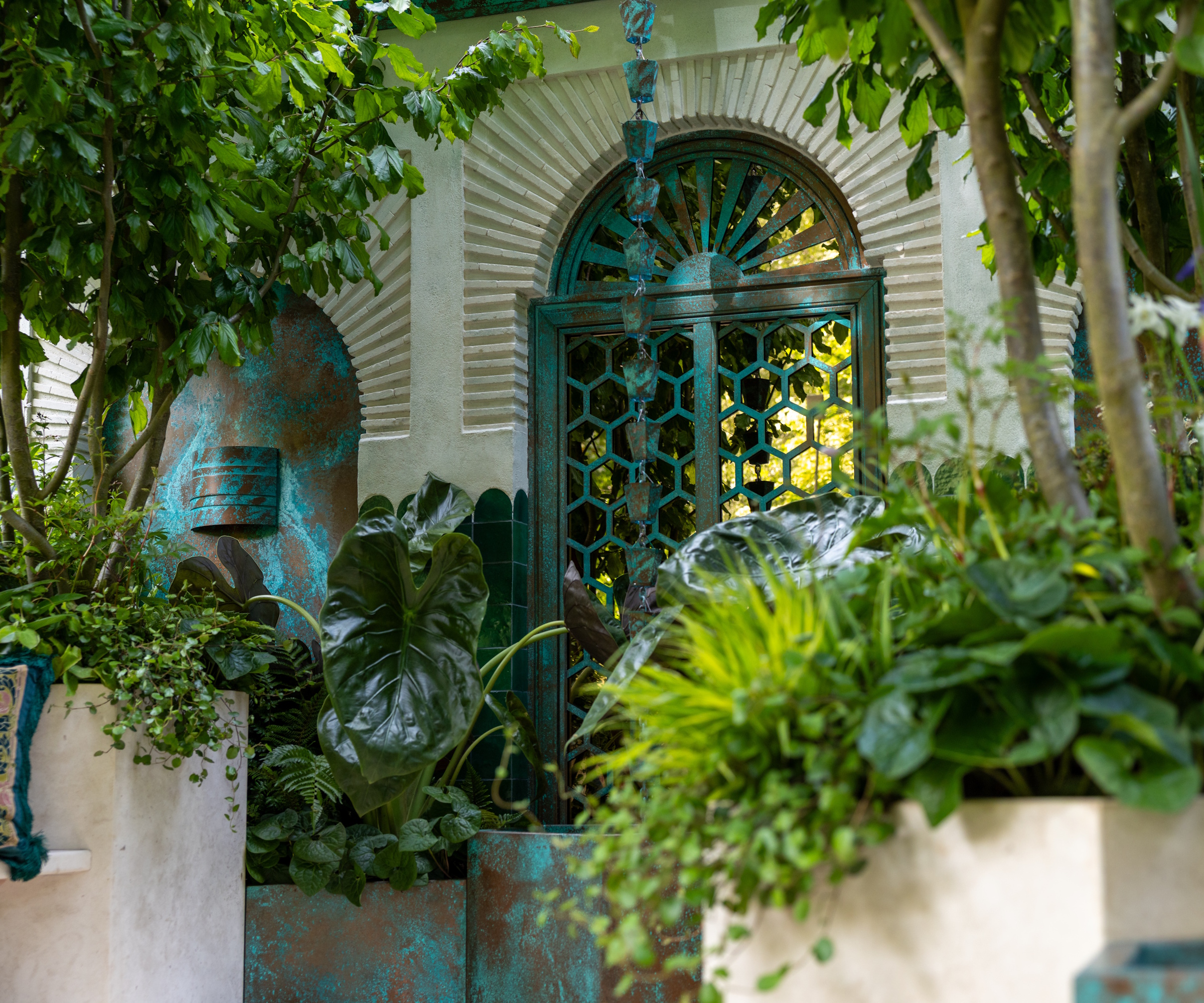 Moroccan inspired courtyard garden with blue copper rain chain