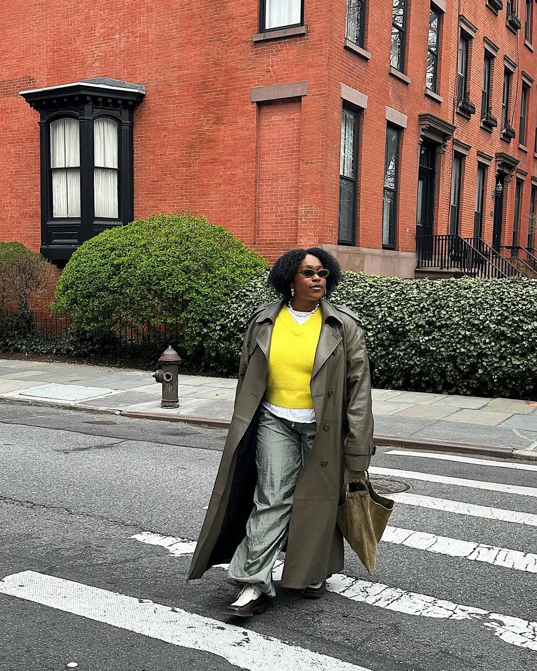 Aniyah Morinia wearing an olive green handbag