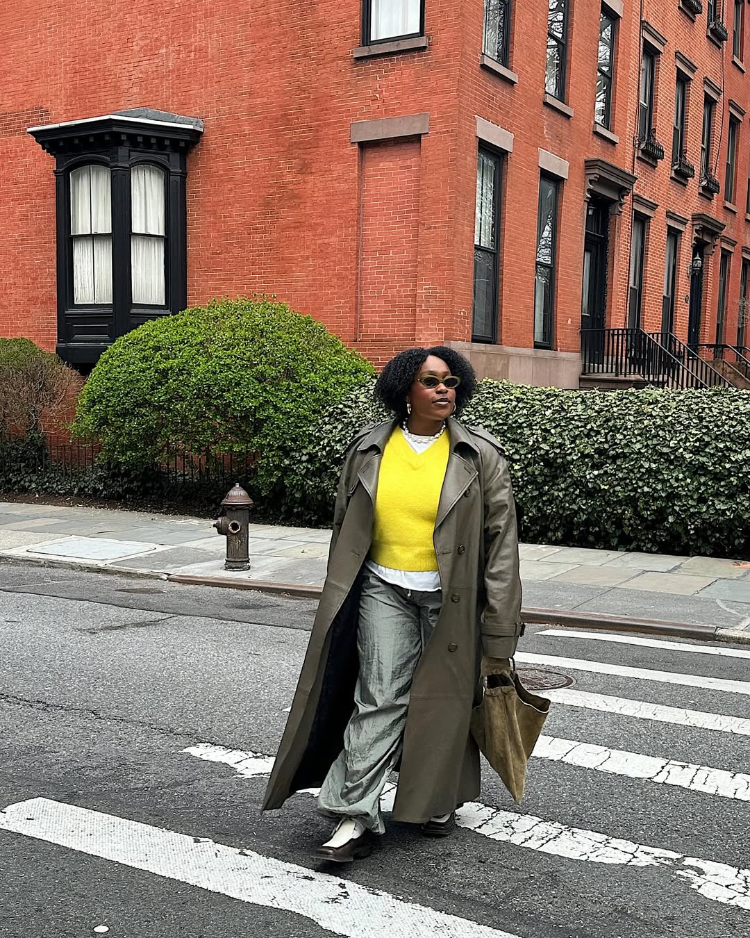 Aniyah Morinia wearing an olive green handbag