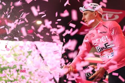 Team UAE's Slovenian rider Tadej Pogacar celebrates on the podium his overall leader's pink jersey after the 3rd stage of the 107th Giro d'Italia cycling race, 166 km between Novara and Fossano, on May 6, 2024 in Fossano. (Photo by Luca Bettini / AFP)
