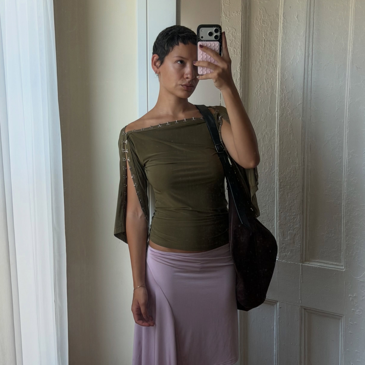 An image of a woman wearing asymmetric skirt outfit summer 2026
