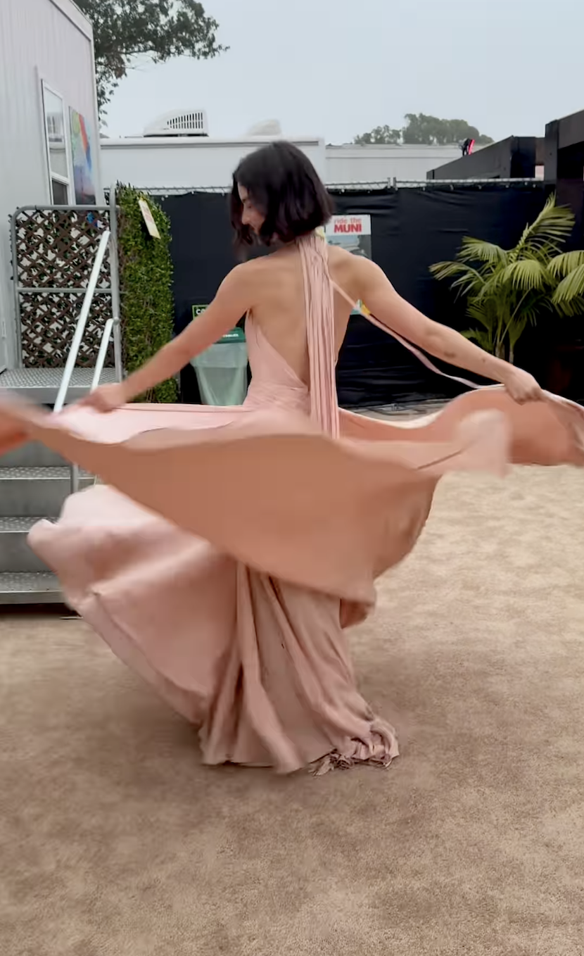 Gracie Abrams wearing a custom GapStudio by Zac Posen blush pink cape dress