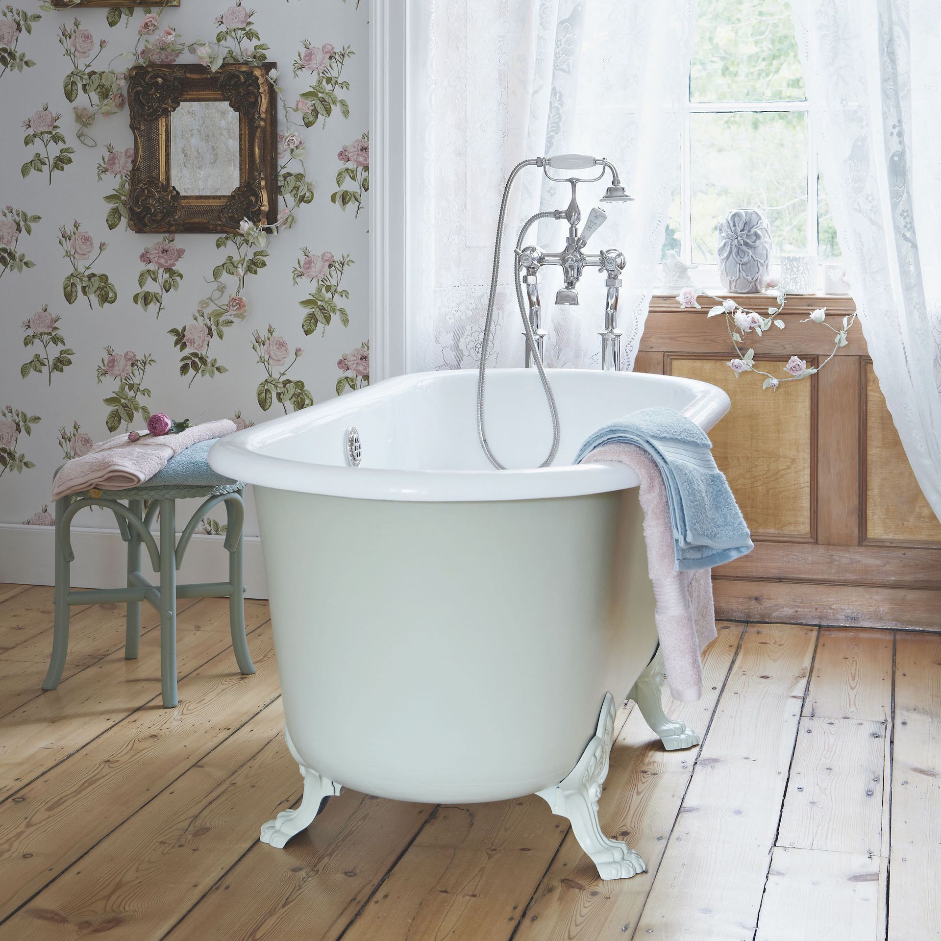 mint green bath in period bathroom with wallpaper
