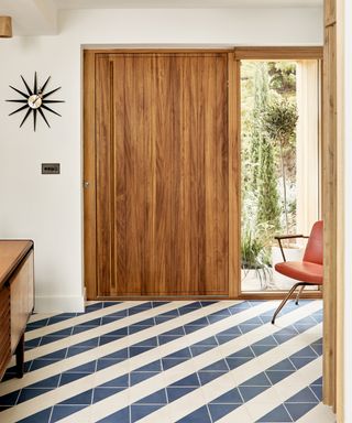 blue and white diagonal striped floor tiles with large oak modern front door