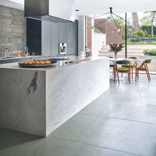 Kitchen with polished concrete island and large tiled floor