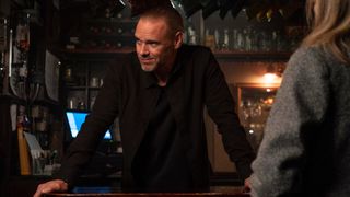 Braden stands at the bar in Code of Silence