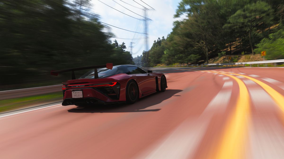 Forza Horizon 6 best cars: The 2025 GR GT Prototype driving around a corner on a wide road in a forest.
