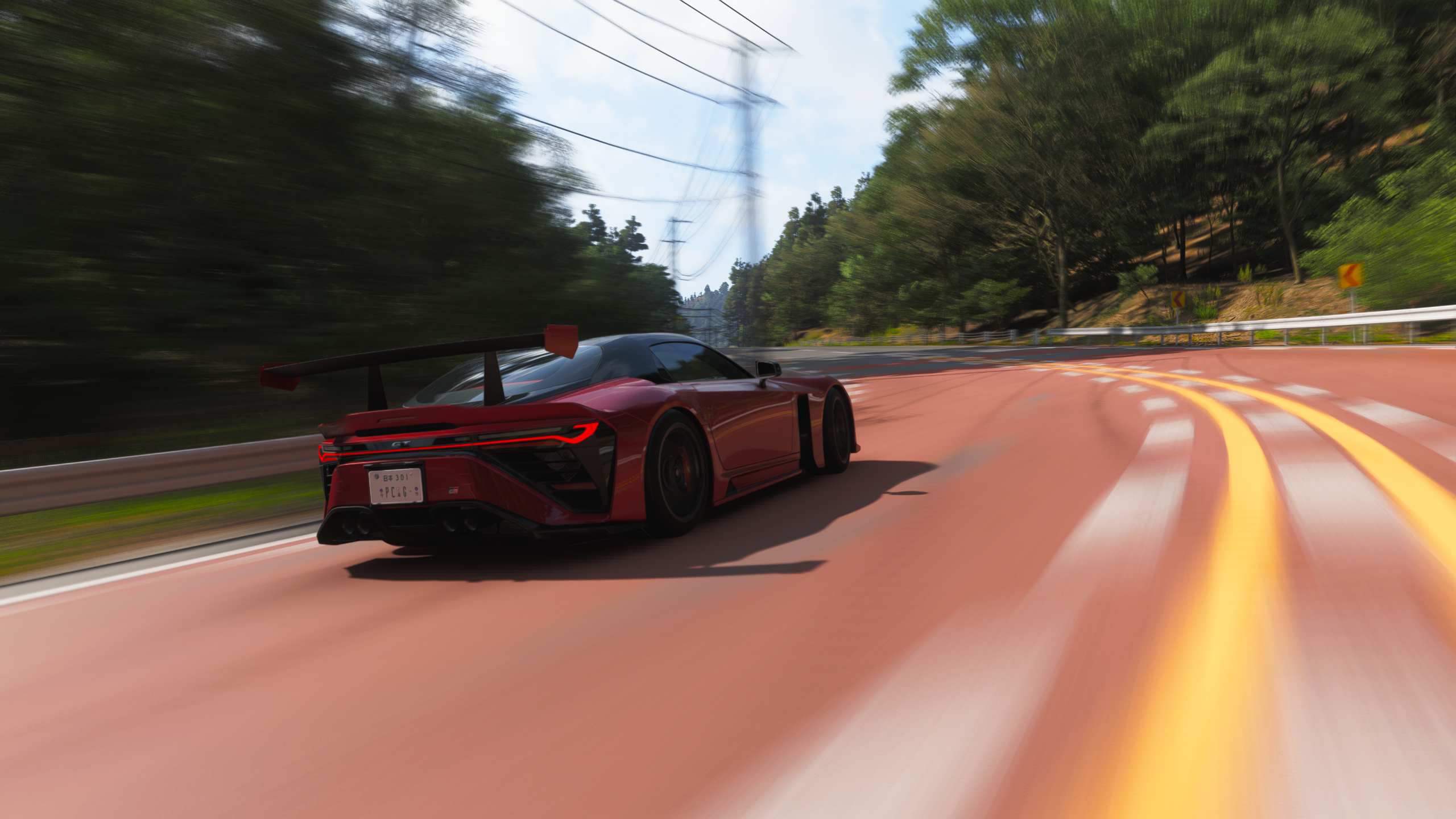 Forza Horizon 6 best cars: The 2025 GR GT Prototype driving around a corner on a wide road in a forest.