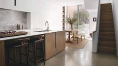 A modern basement conversion kitchen with a kitchen island with bar stool seating