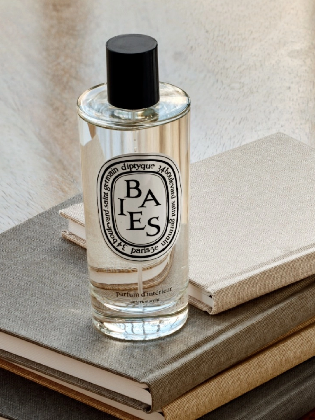 A glass bottle of berry room spray from Diptyque