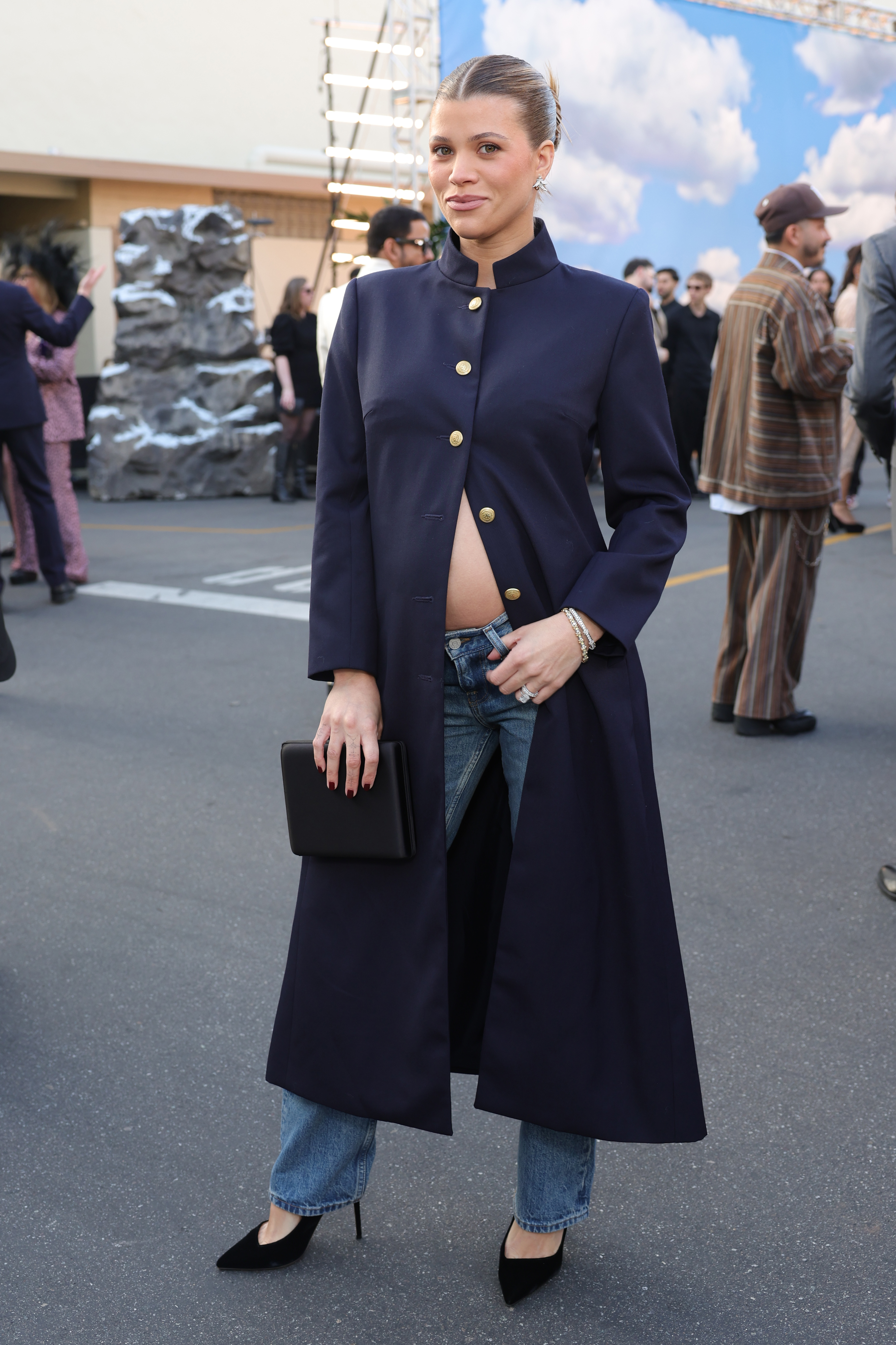 Sofia Richie Grainge wearing an open coat with jeans and heels