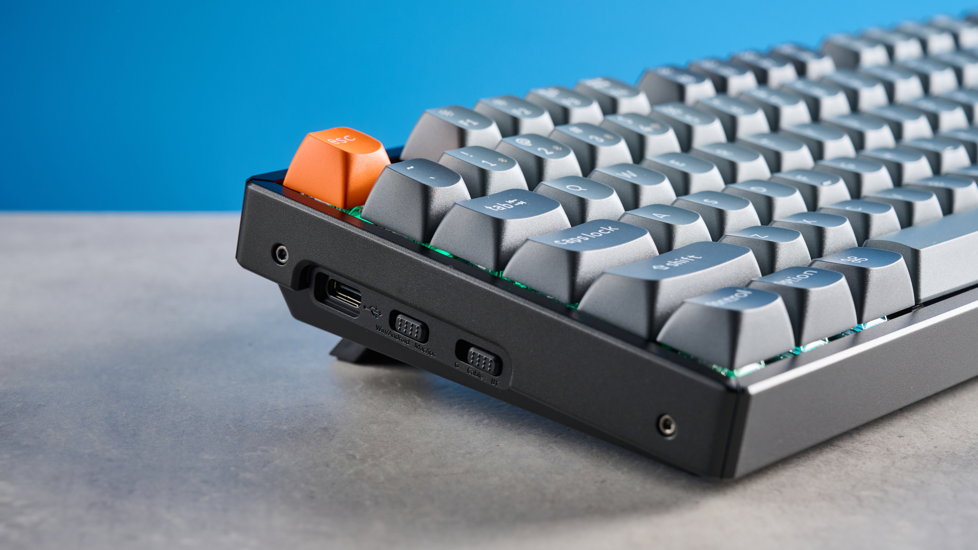 Keychron K8 Max mechanical keyboard in gray photographed on a blue background