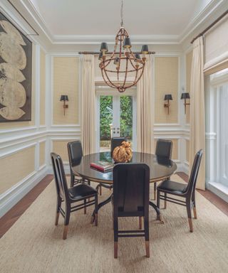 dining room with black table and chairs and cream walls