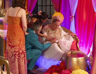 Dev grips Bernie Winters' hand as she collapses on their wedding day