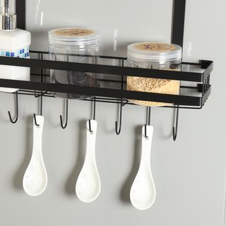 spice rack that hangs over a door, three hanging spoons