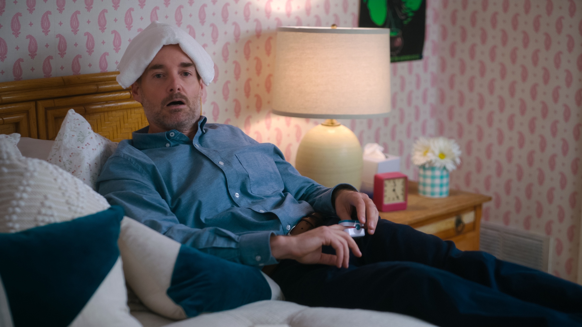 Jack lies on the bed with a towel on his head in The Four Seasons