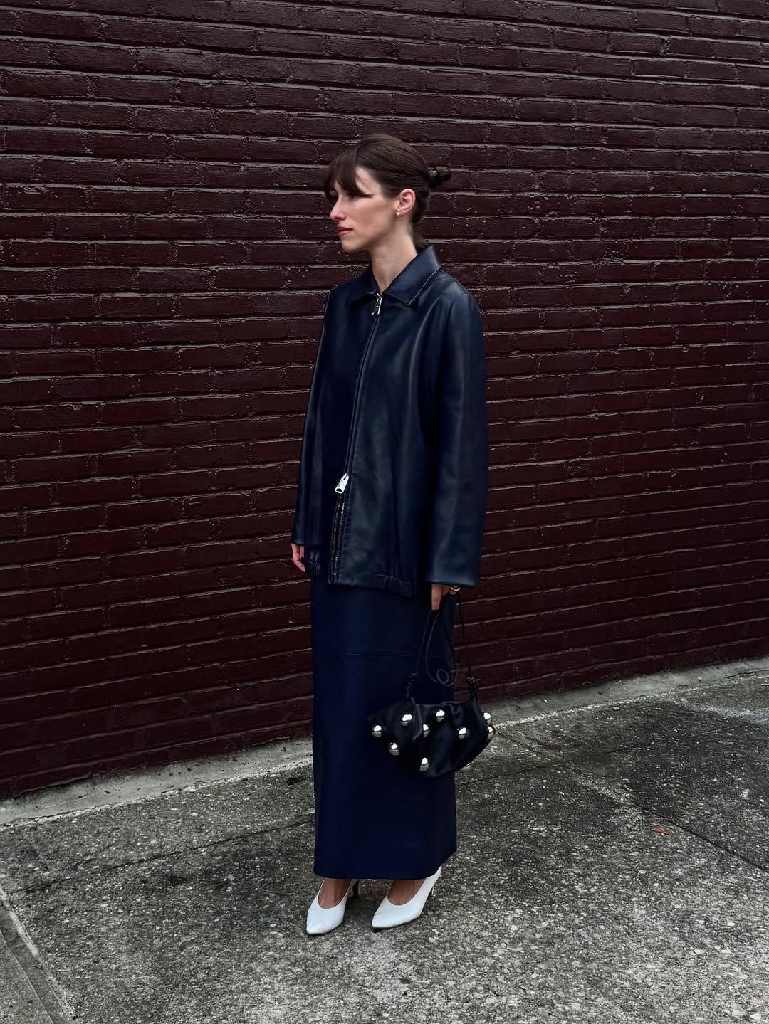 Woman wearing collared leather jacket trend fall 2025.