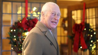 King Charles III smiles during the The King's Foundation's annual 'Crafts at Christmas' at Highgrove Gardens on December 13, 2024