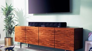 Sennheiser Ambeo Soundbar Max on a sideboard under a flatscreen TV